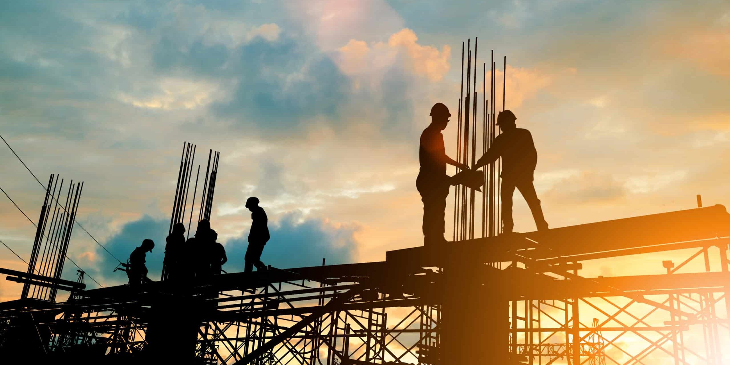 Silhouette of engineer and construction team working at site over blurred background sunset pastel for industry background with Light fair.Create from multiple reference images together. Commercial Construction Dumpster Rental